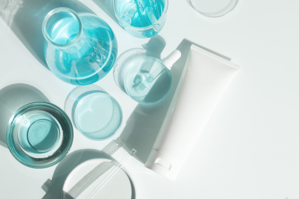 skincare products, and scientific beakers, in light aqua blue
