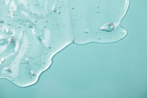 Hyaluronic,Acid spilled on blue background