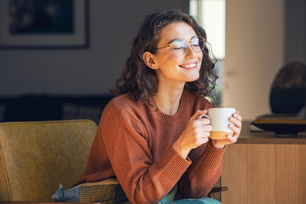 Woman looking happy with cup of tea