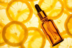 lemon slices on a backlit screen, with a vitamin C serum