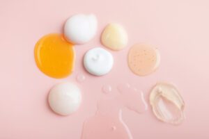 skincare routine options, serums, gels, creams, on pink background