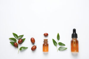 jojoba oil, seeds, and bottle of oil