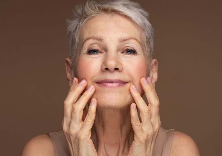 woman with short grey hair, putting skincare on